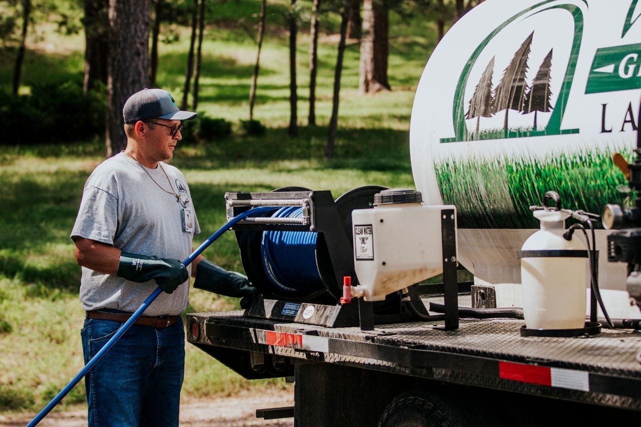 Warne Green Force worker preparing for landscape spraying with a Warne Green Force truck