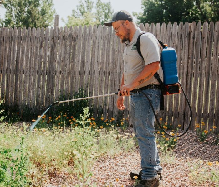 Warne Green Force worker spraying bare ground to prevent weeds Warne Green Force worker spraying bare ground to prevent weeds